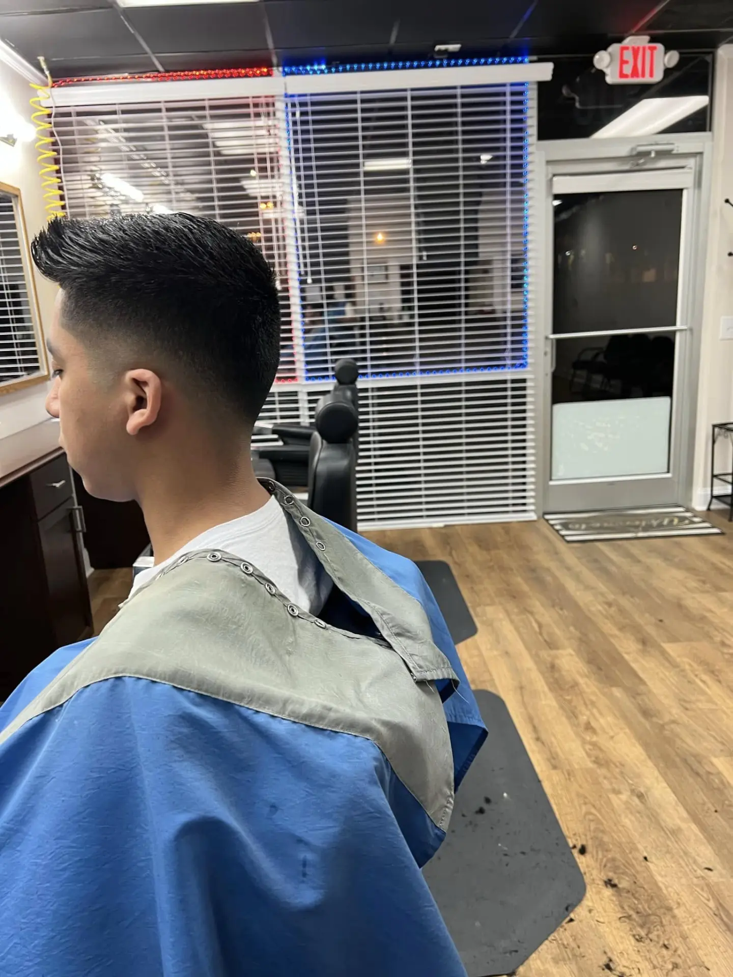 Low fade with brushed-up pompadour styled at The Final Touch Hair Studio